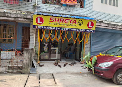 Shreya Motor Training School entrance with its sign and a red training car